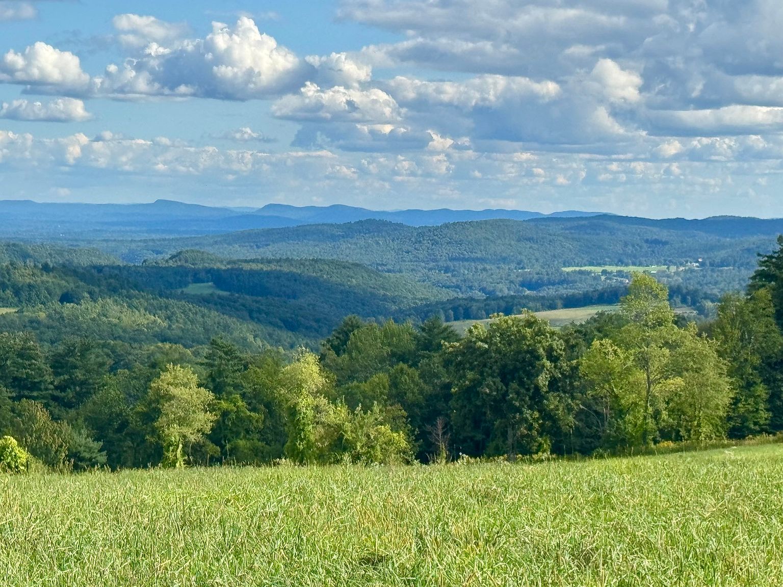Looking south from the upper meadow across layered hills toward the Mount Holyoke Range